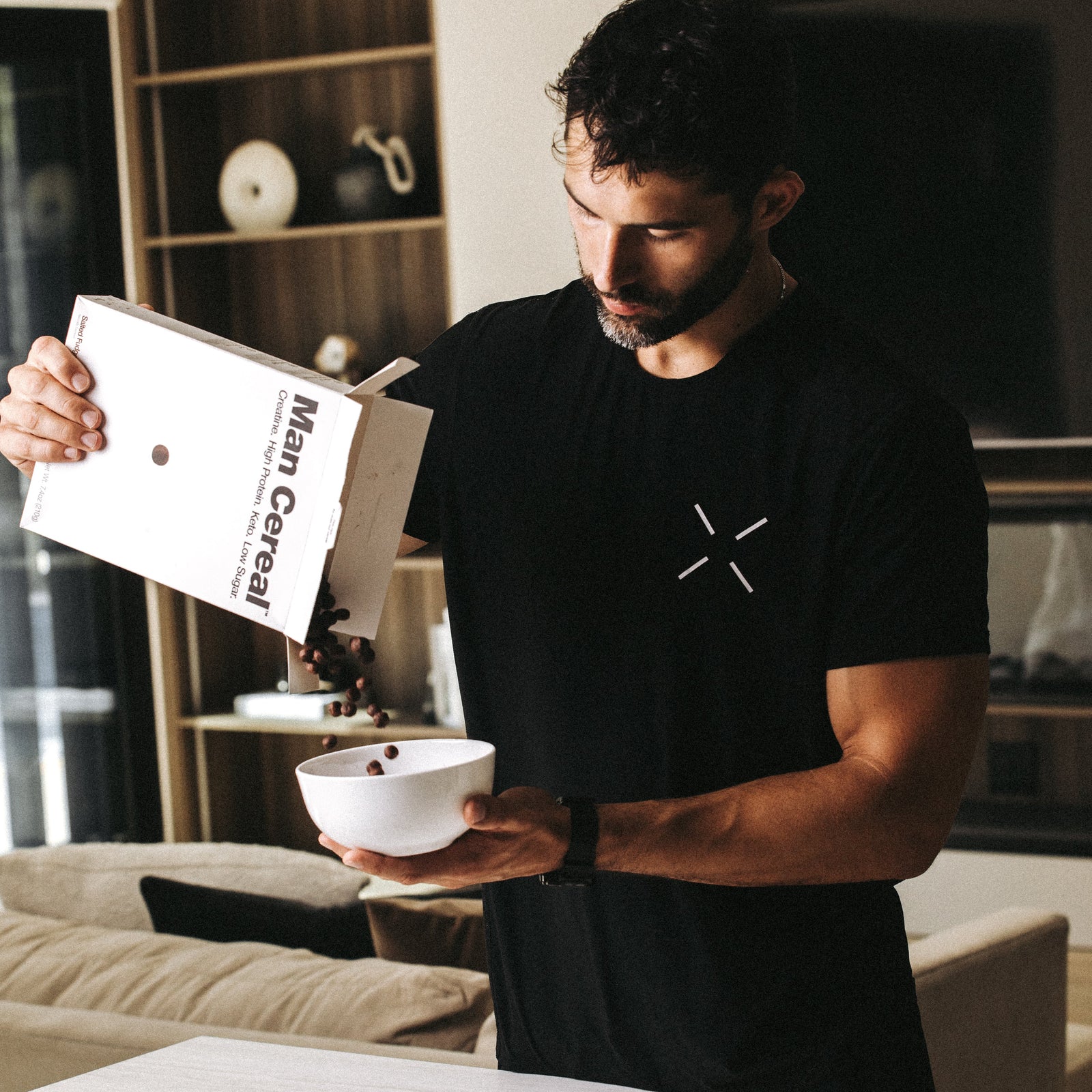 Man pouring a bowl of cereal in a modern kitchen